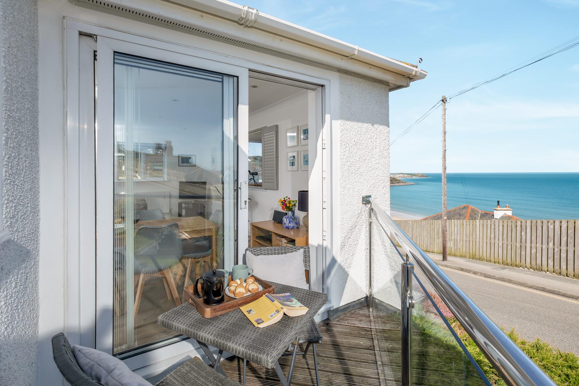 Step onto the decked balcony and watch the waves ebb and flow.