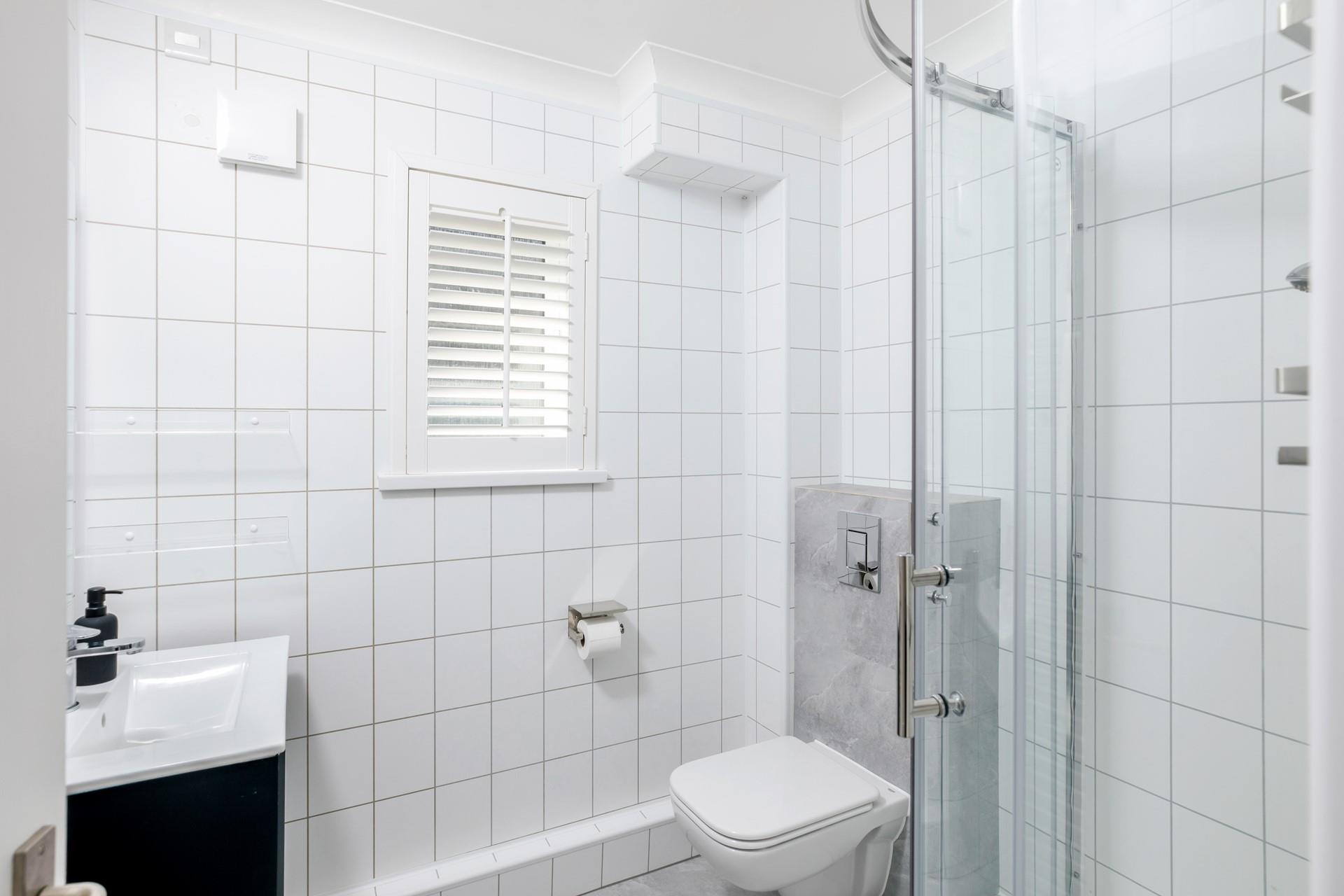 The shower room is modern and sleek.