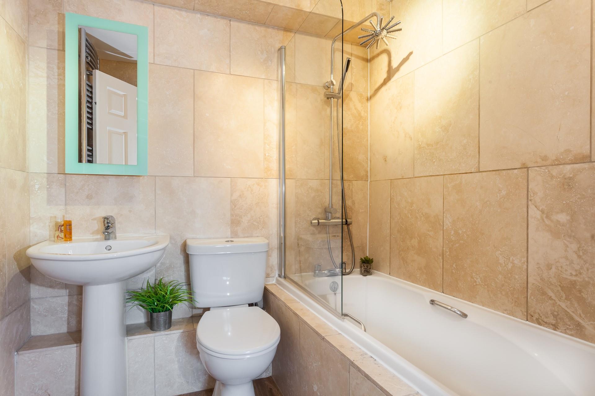 Perfectly practical, the bathroom is modern and stylish. 