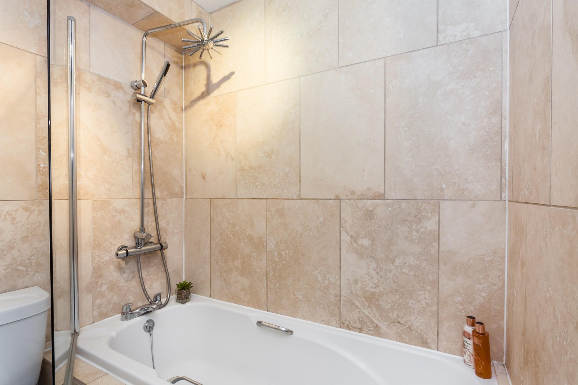 Indulge in a long shower under the feature rainfall shower head.