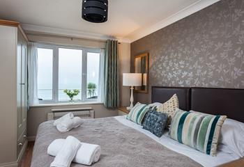 The bedroom has a super king size bed with a lovely outlook over the sea.