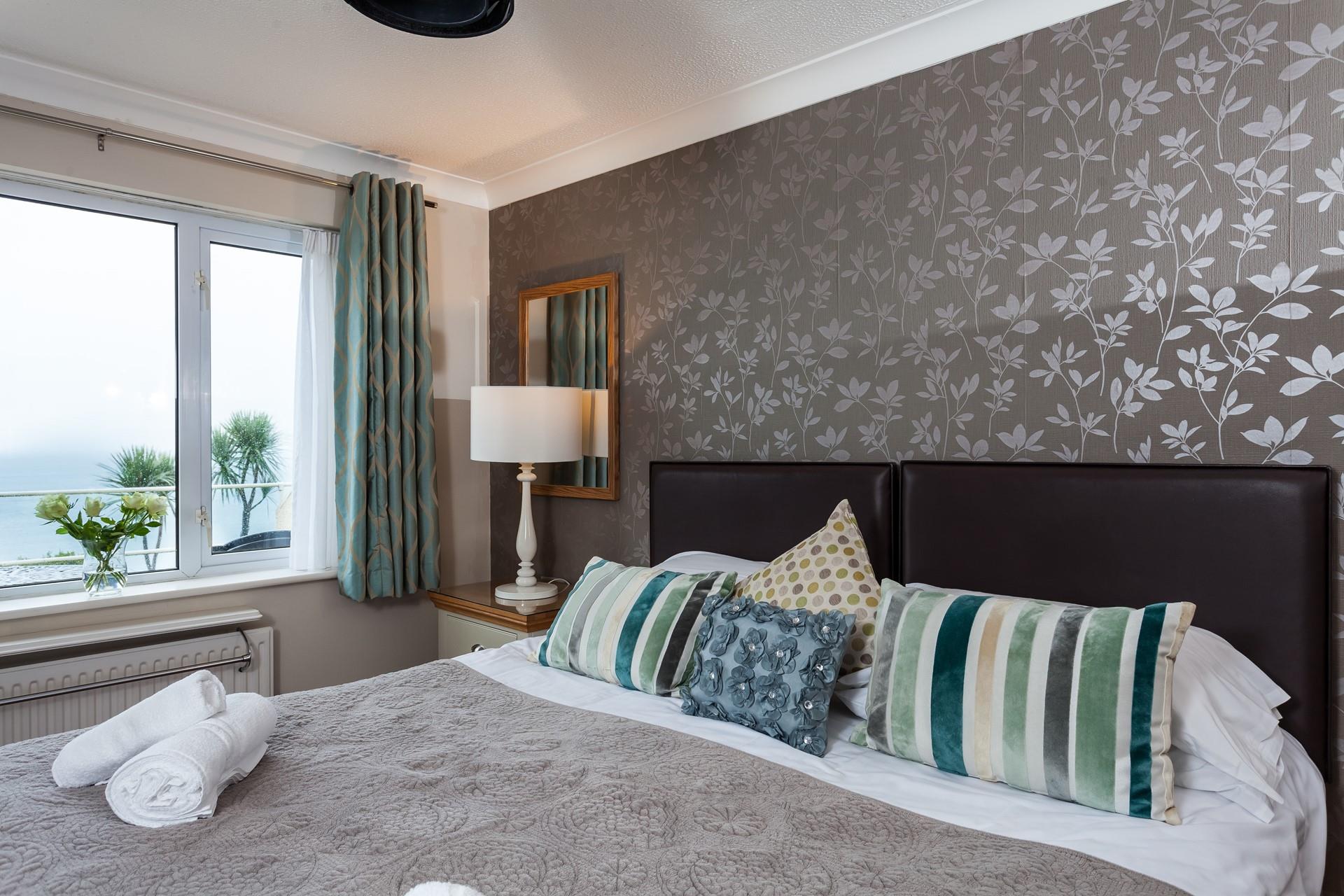 Beautifully designed with an elegant feature wall, the bedroom has a luxurious and romantic finish. 