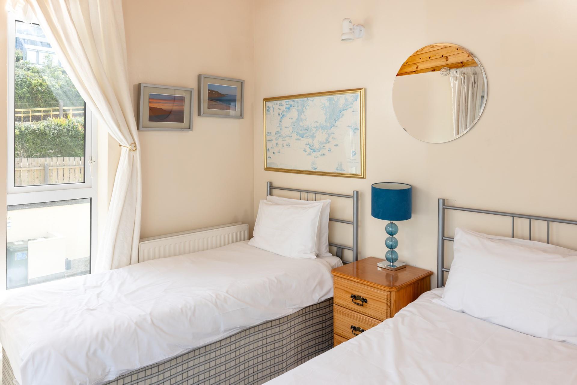 Bedroom 1 has twin beds and its own private balcony.