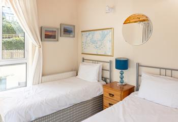 Bedroom 1 has twin beds and its own private balcony.