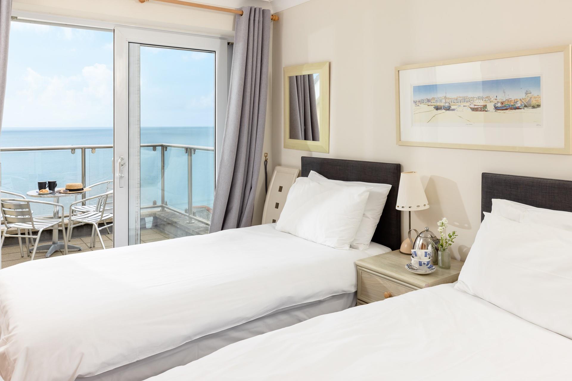 Step from the twin room onto the sea-facing balcony to enjoy your morning coffee.