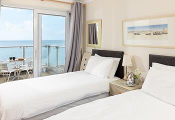 Step from the twin room onto the sea-facing balcony to enjoy your morning coffee.