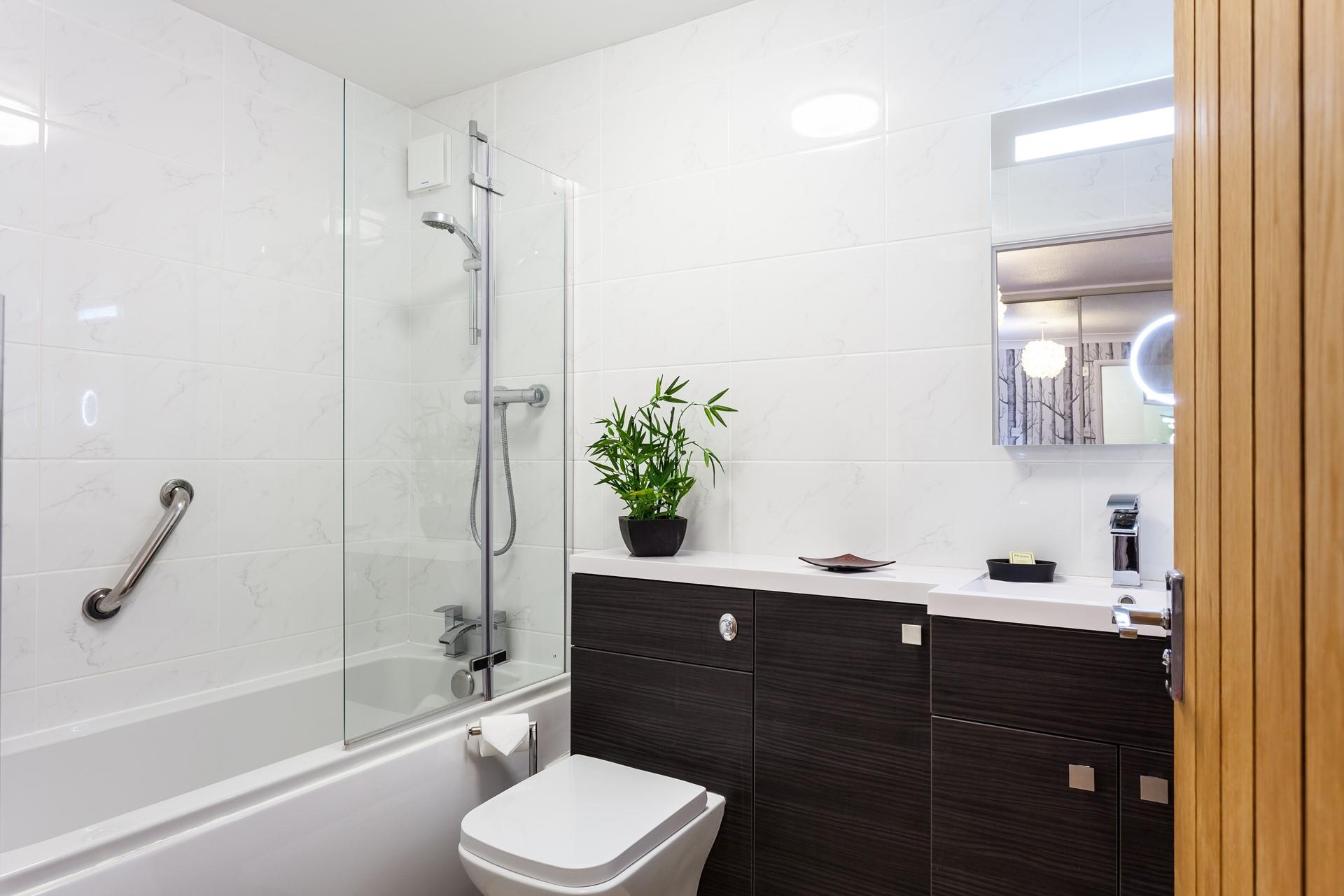 The family bathroom has a well-sized bath with a mains shower attachment above, the WC and basin are fully fitted with cupboards for handy storage.