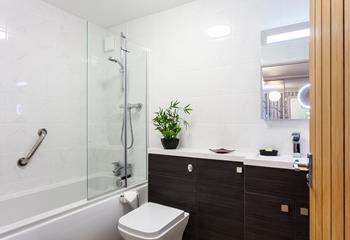 The family bathroom has a well-sized bath with a mains shower attachment above, the WC and basin are fully fitted with cupboards for handy storage.