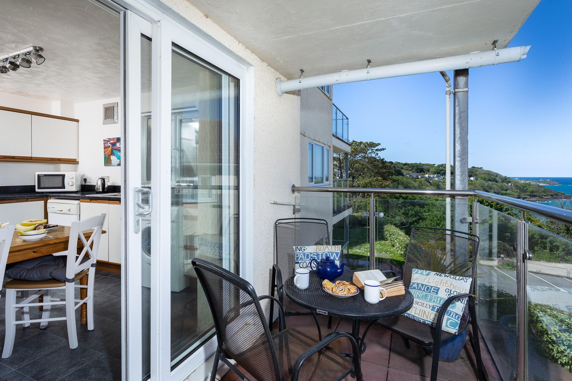 The patio doors from the kitchen lead to the private balcony, perfect for dining al fresco. 