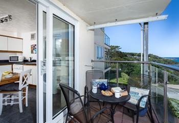 The patio doors from the kitchen lead to the private balcony, perfect for dining al fresco. 