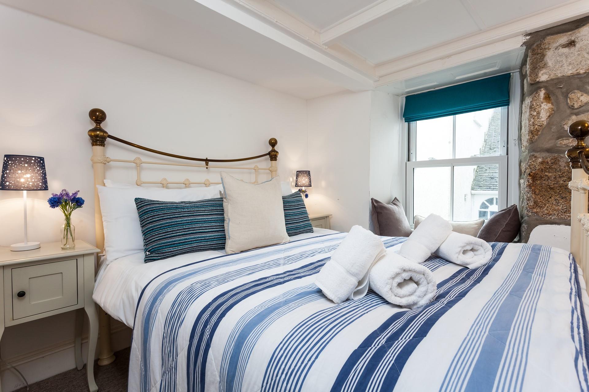 Seaside blues in bedroom 1 create a calming place to unwind at the end of a busy day.