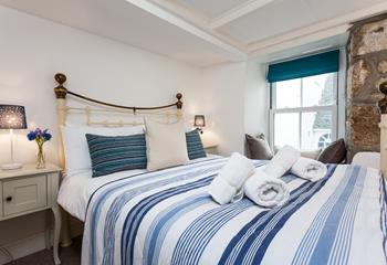 Seaside blues in bedroom 1 create a calming place to unwind at the end of a busy day.