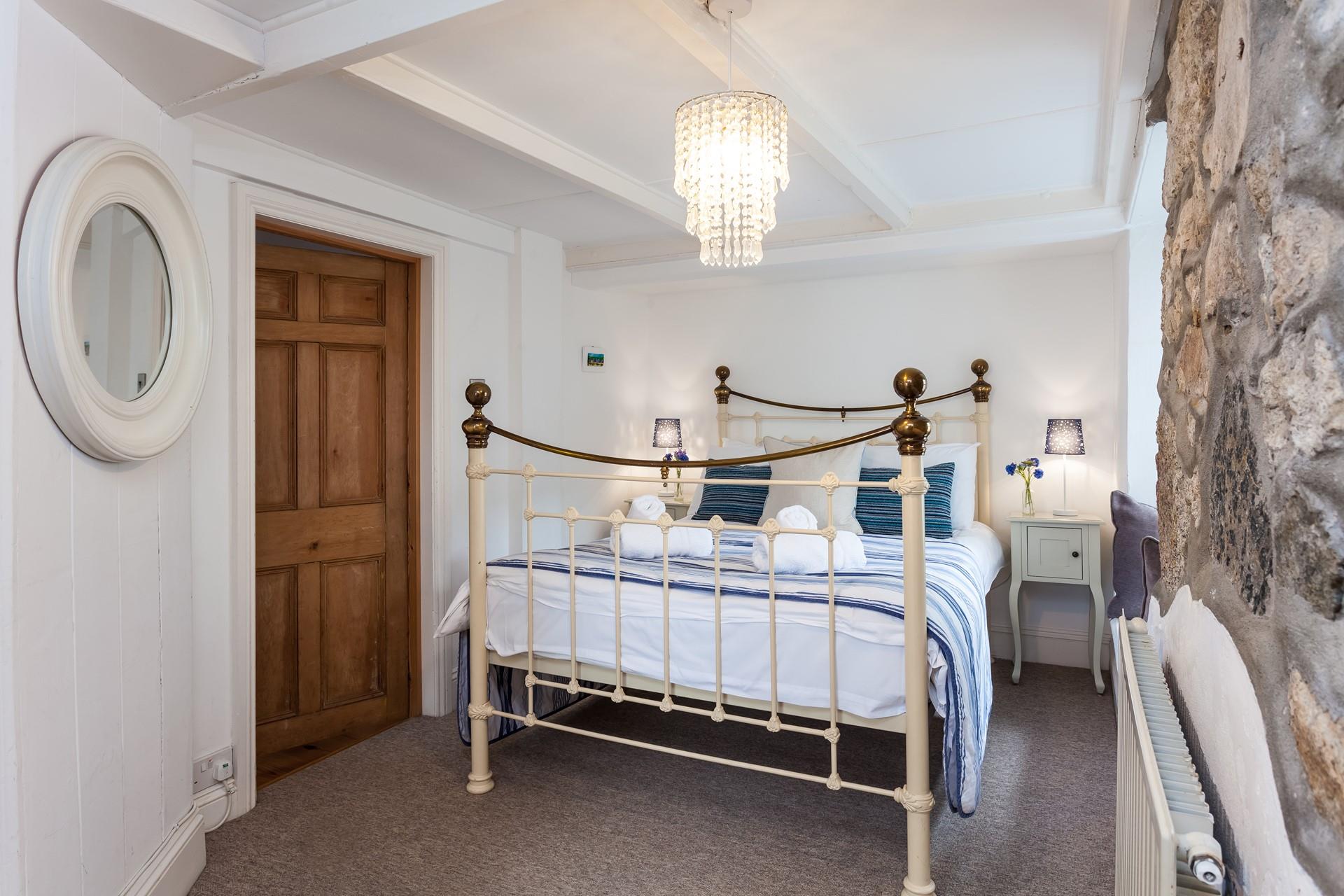 The exposed granite walls are a charming feature in the ground floor double bedroom. 