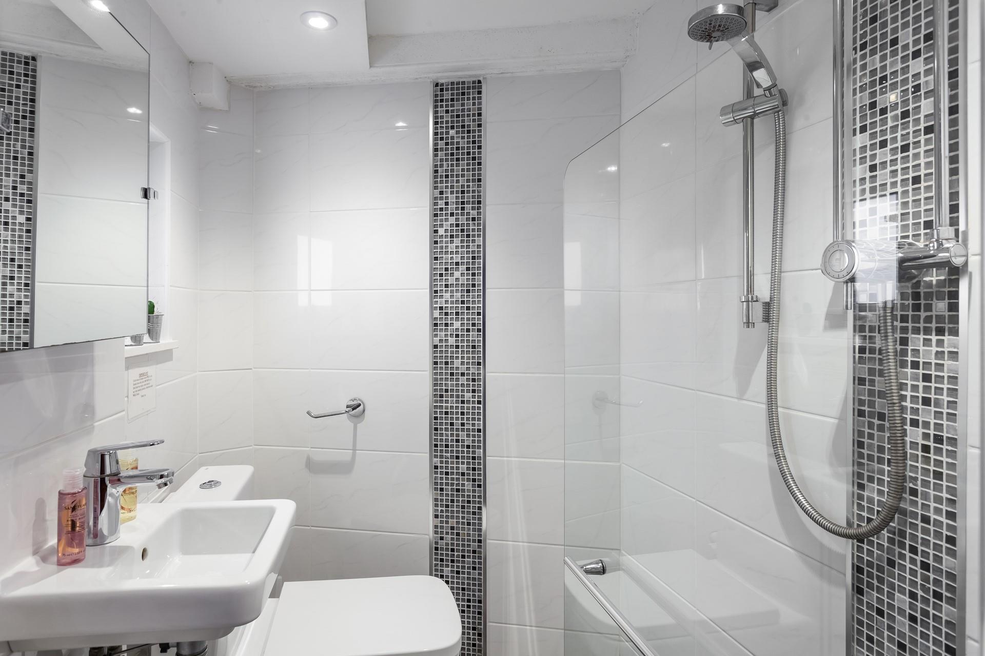 The modern en suite offers privacy and convenience.