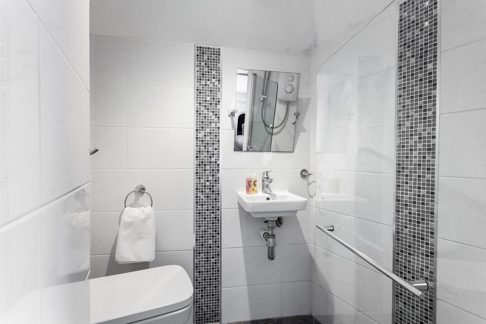 The modern en suite offers luxury and convenience. 