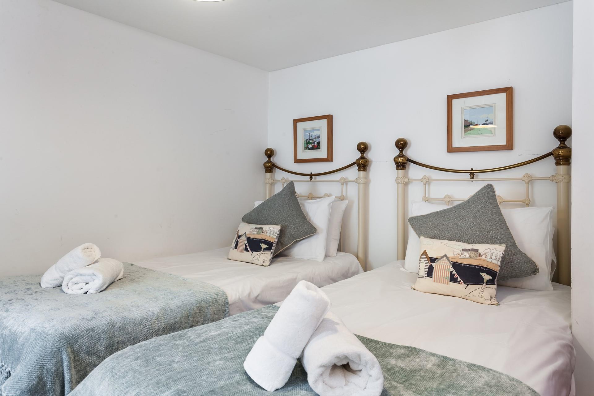 Plump pillows and crisp white linen promise a relaxing night's sleep. 