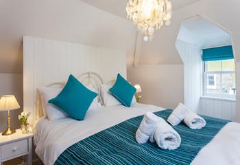 Bright whites and azure blues create an oasis of calm in this stunning bedroom.