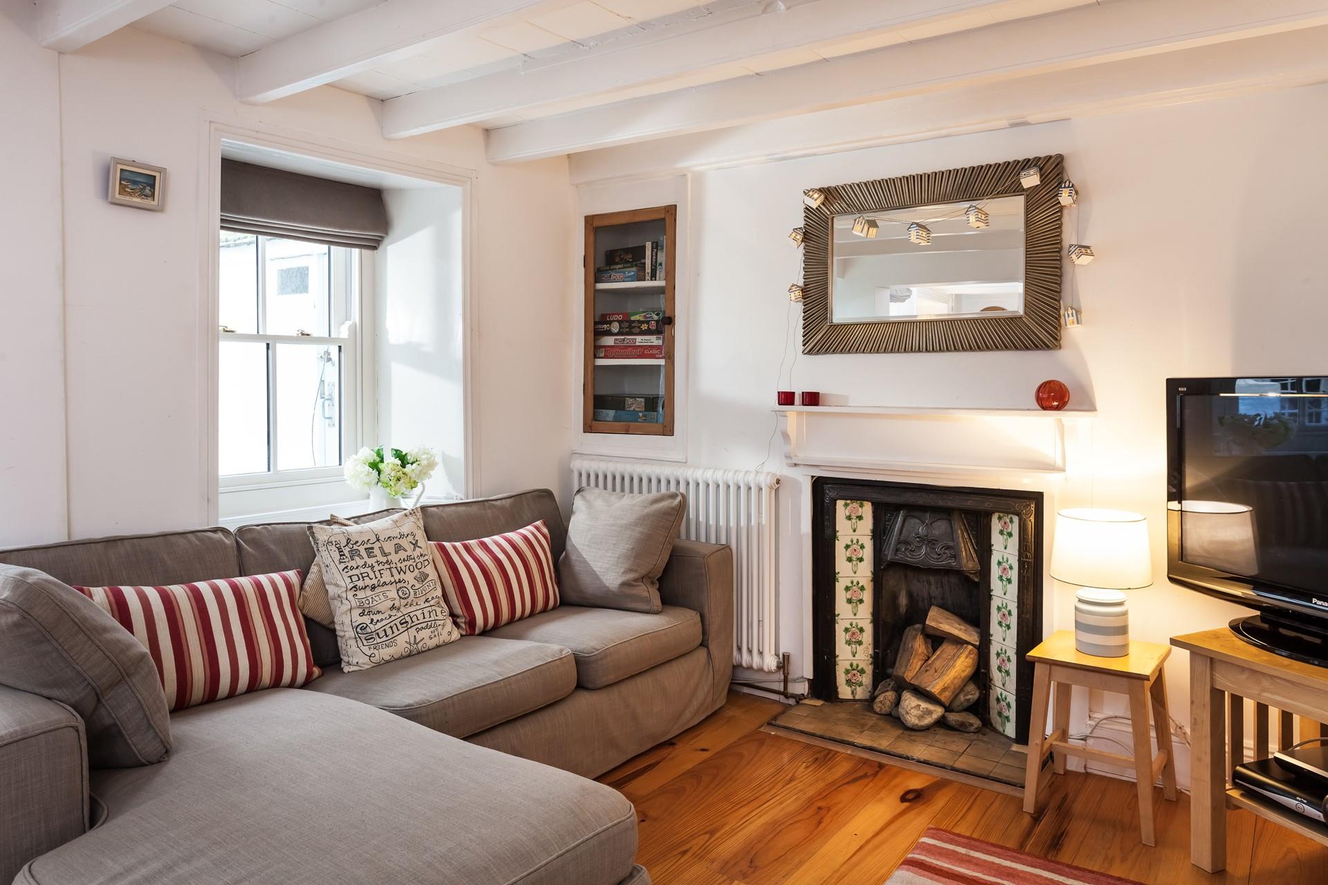 Warm and cosy, with character beams and a fireplace, the sitting room is the perfect place to relax and unwind. 