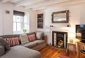 Warm and cosy, with character beams and a fireplace, the sitting room is the perfect place to relax and unwind. 