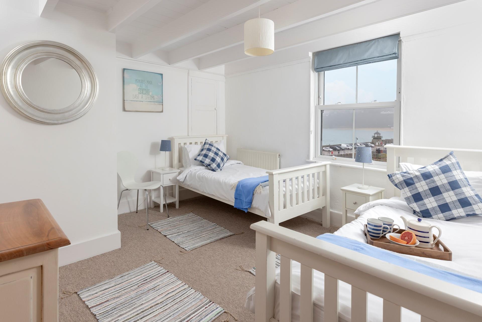 Bedroom 4 boasts views across the harbour. 