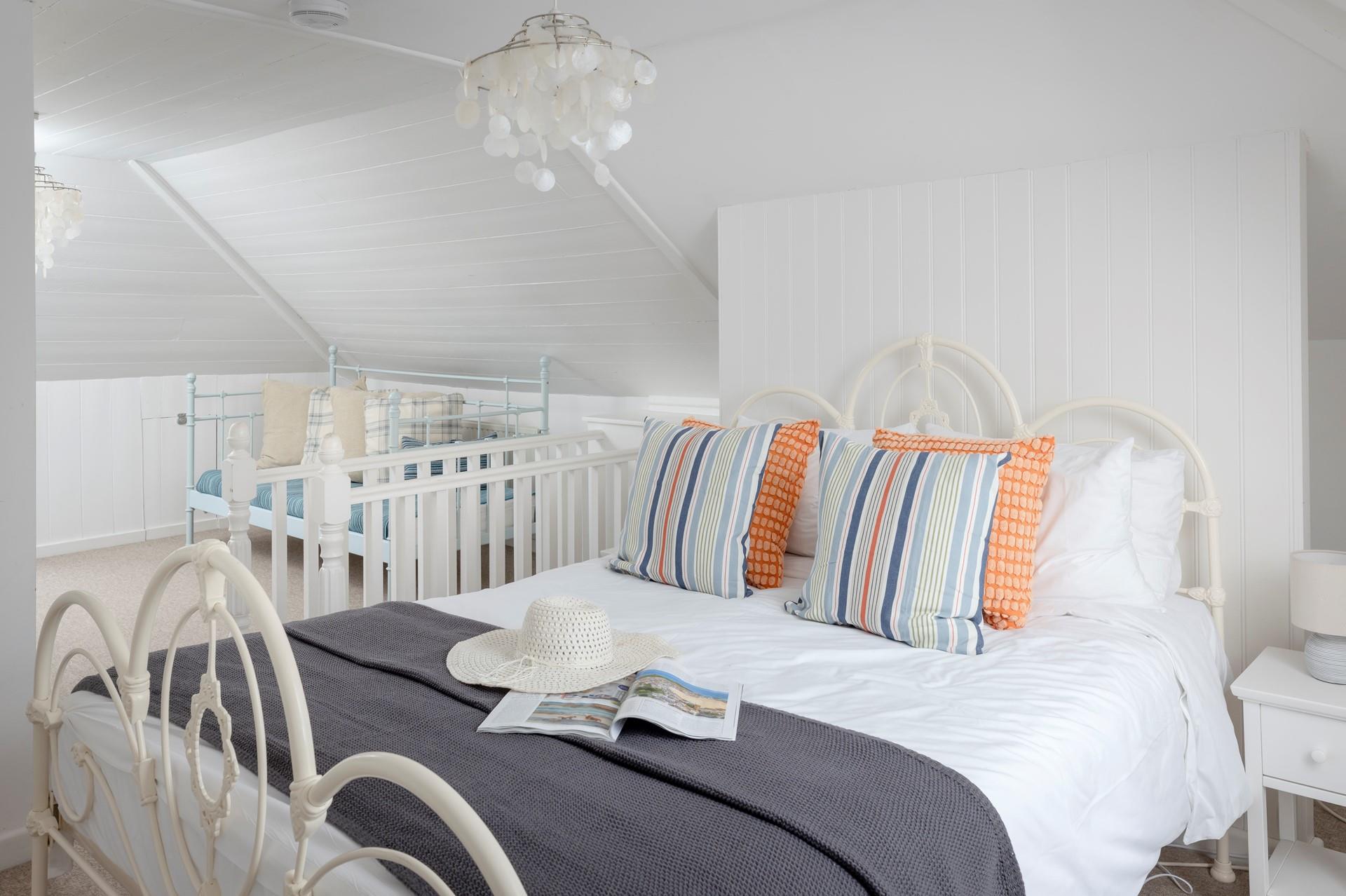 Bright whites and oranges create an oasis of calm in this stunning bedroom.