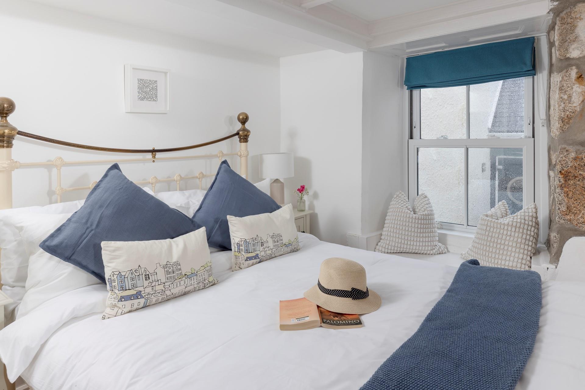 Seaside blues in bedroom 1 create a calming place to unwind at the end of a busy day.