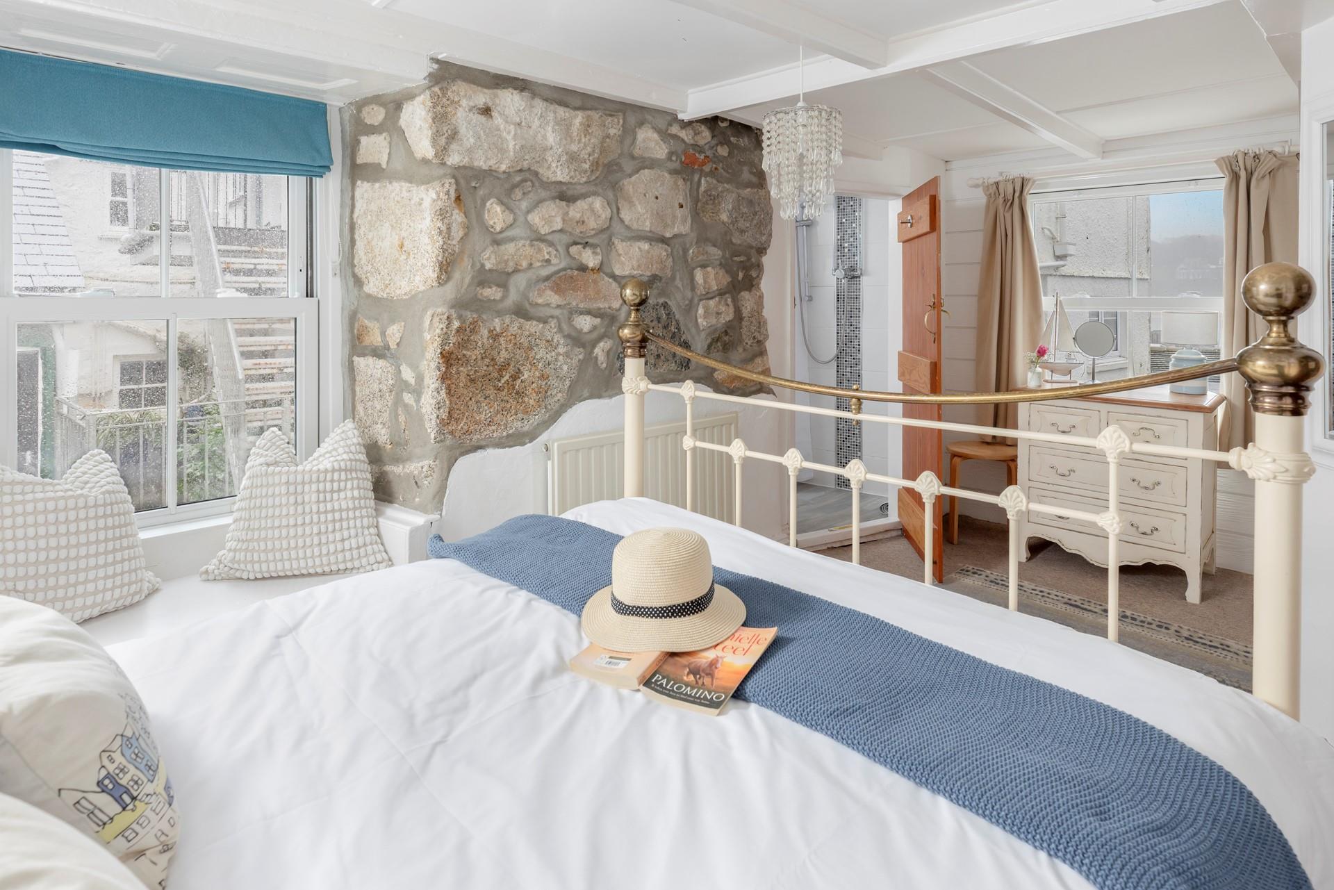 The exposed granite walls are a charming feature in the ground floor double bedroom. 