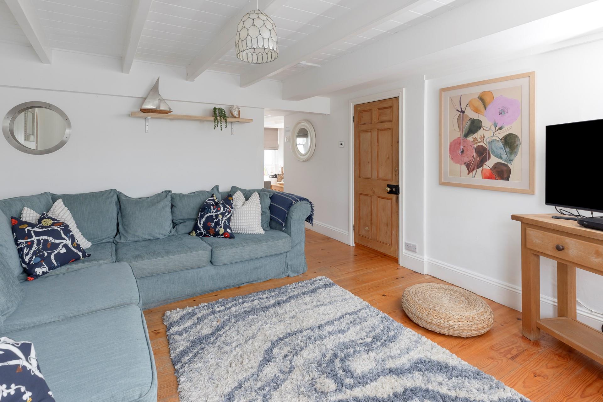 Warm and cosy, with character beams and a fireplace, the sitting room is the perfect place to relax and unwind. 