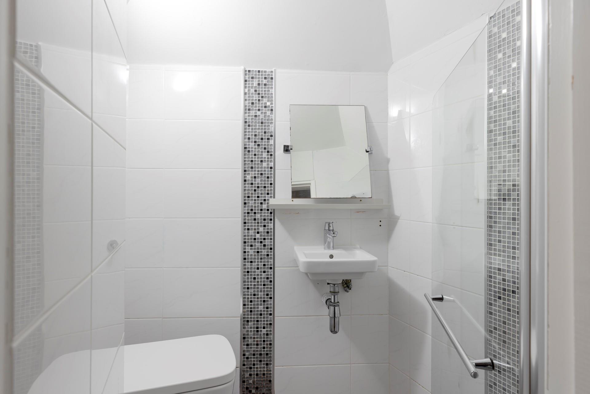 The modern en suite offers privacy and convenience.