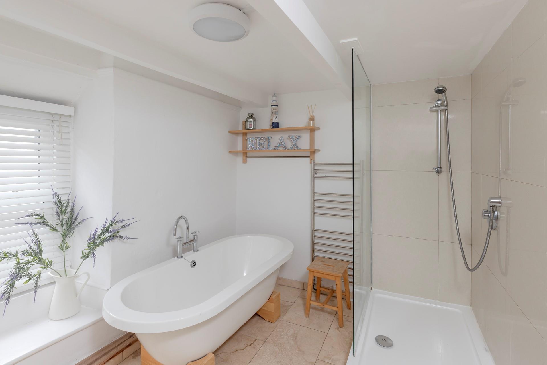 The family bathroom is spacious, with a luxurious free-standing bathtub.