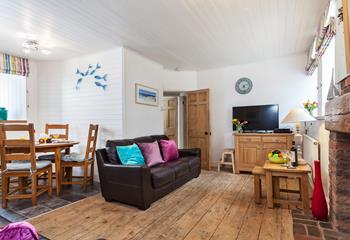 Cosy open plan living with original features, sink into the sofa after a busy day of exploring.