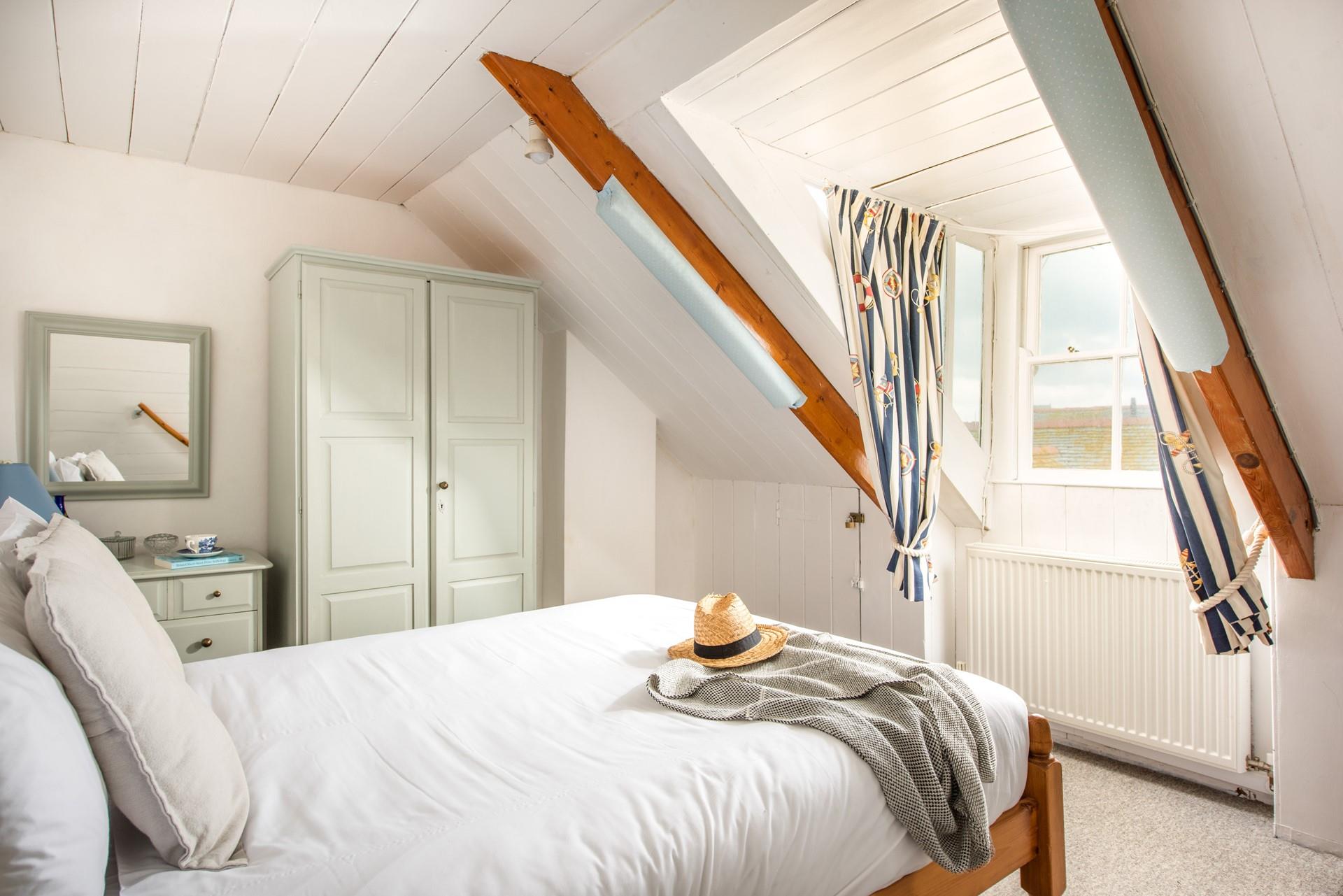 The quirky attic bedroom is cosy and characterful.