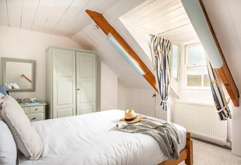 The quirky attic bedroom is cosy and characterful.
