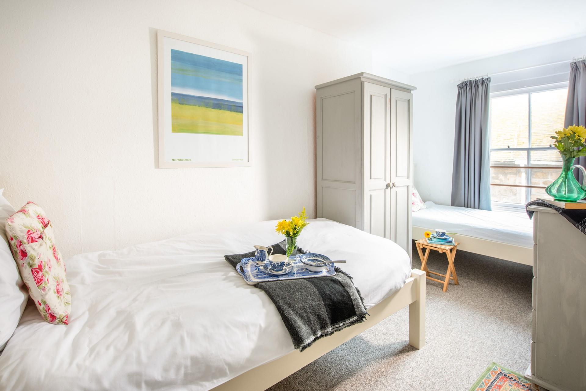 The twin bedroom with its soft colour palette is perfect for children.