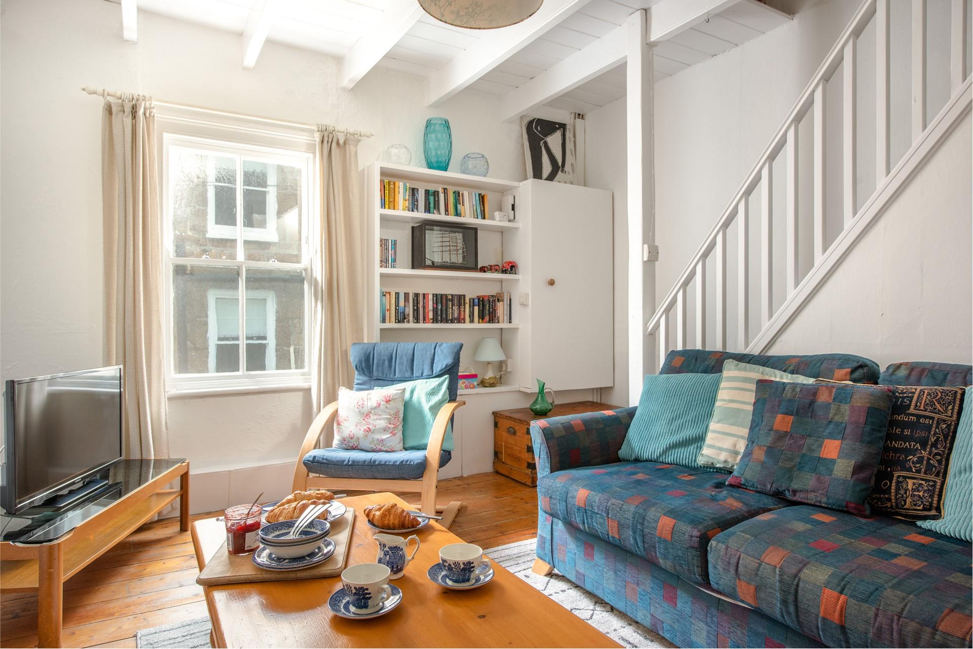 Exposed beams and wood flooring add to the property's character. 