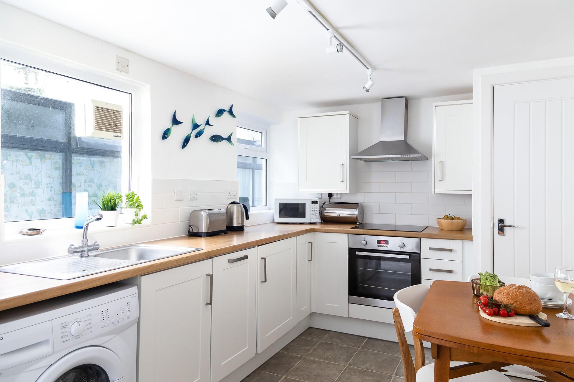 The kitchen is bright and breezy with modern appliances that make it a pleasure to cook up delicious meals.