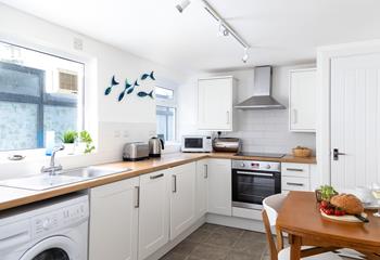 The kitchen is bright and breezy with modern appliances that make it a pleasure to cook up delicious meals.