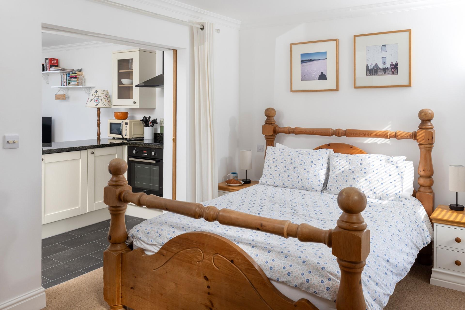 The bedroom's traditional wooden furniture offers a classic and homely space, perfect for relaxing.