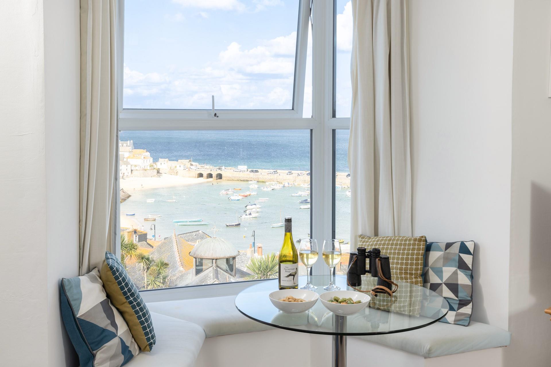 Sit in the window seat and take in the lovely views with a cold glass of wine.