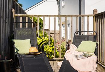Sunloungers on the raised and terraced decking area are the perfect sunbathing spot.
