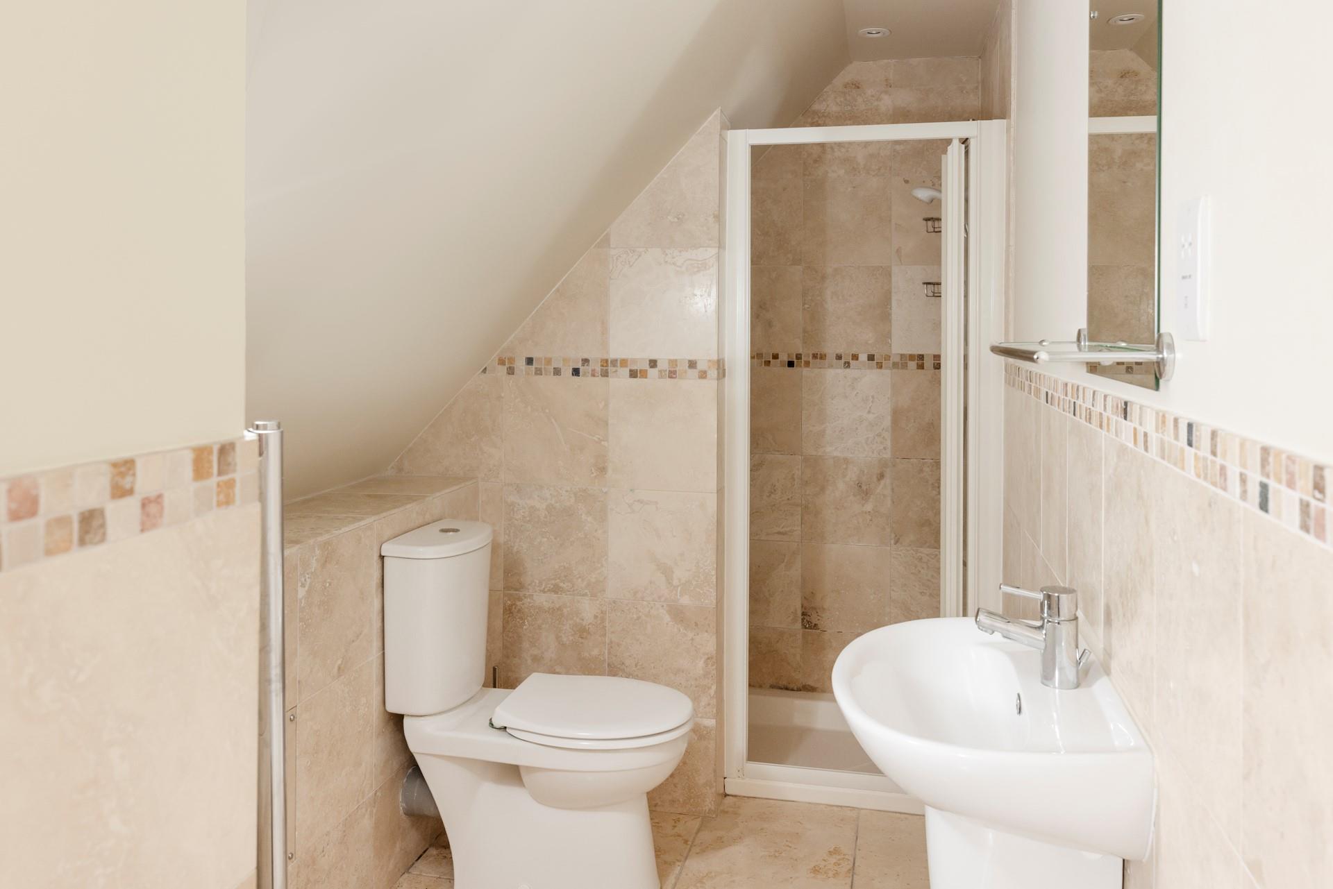 The en suite has a calming spa-like feel.