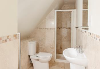 The en suite has a calming spa-like feel.