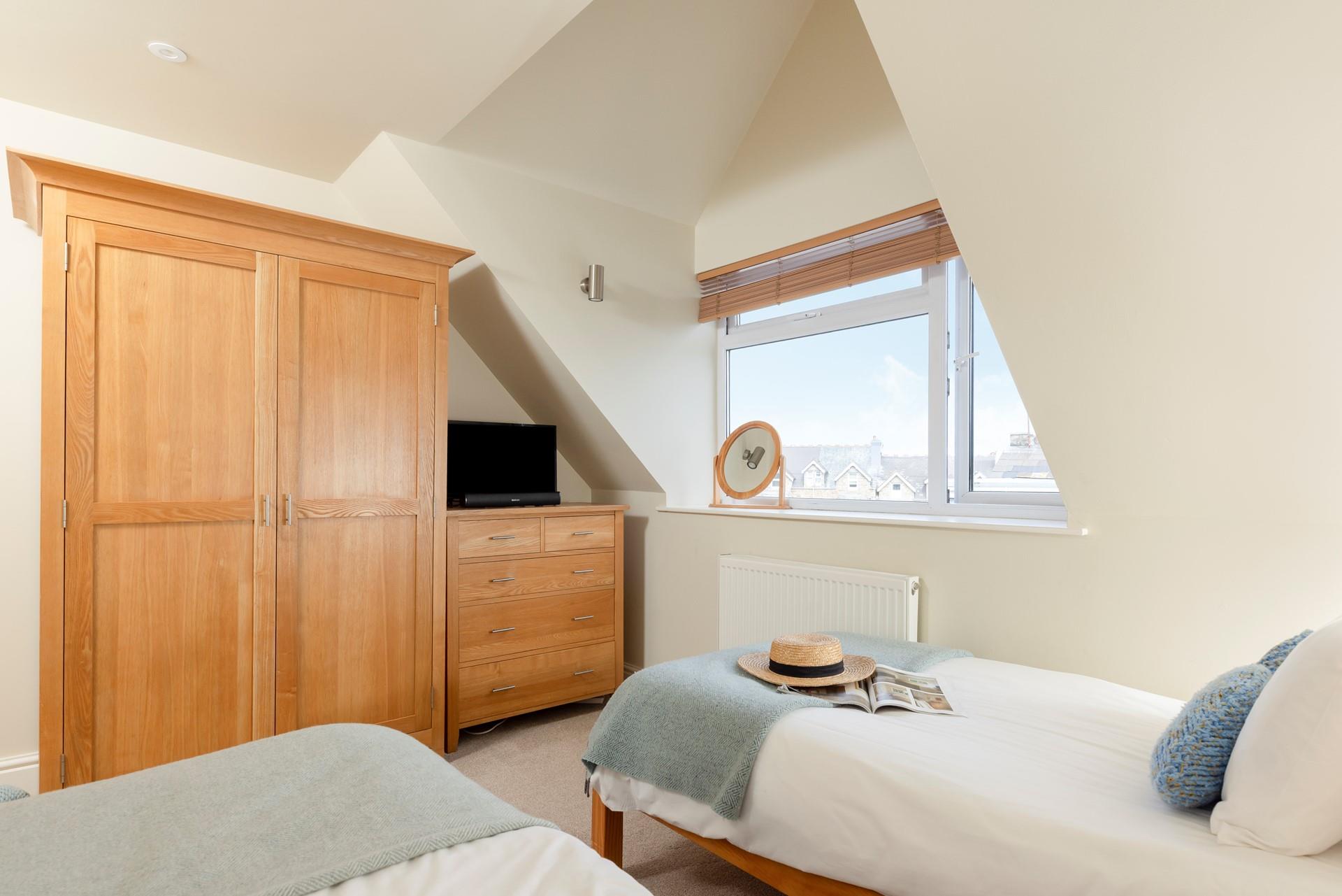 Ideal for kids or adults, the twin bedroom has plenty of storage.