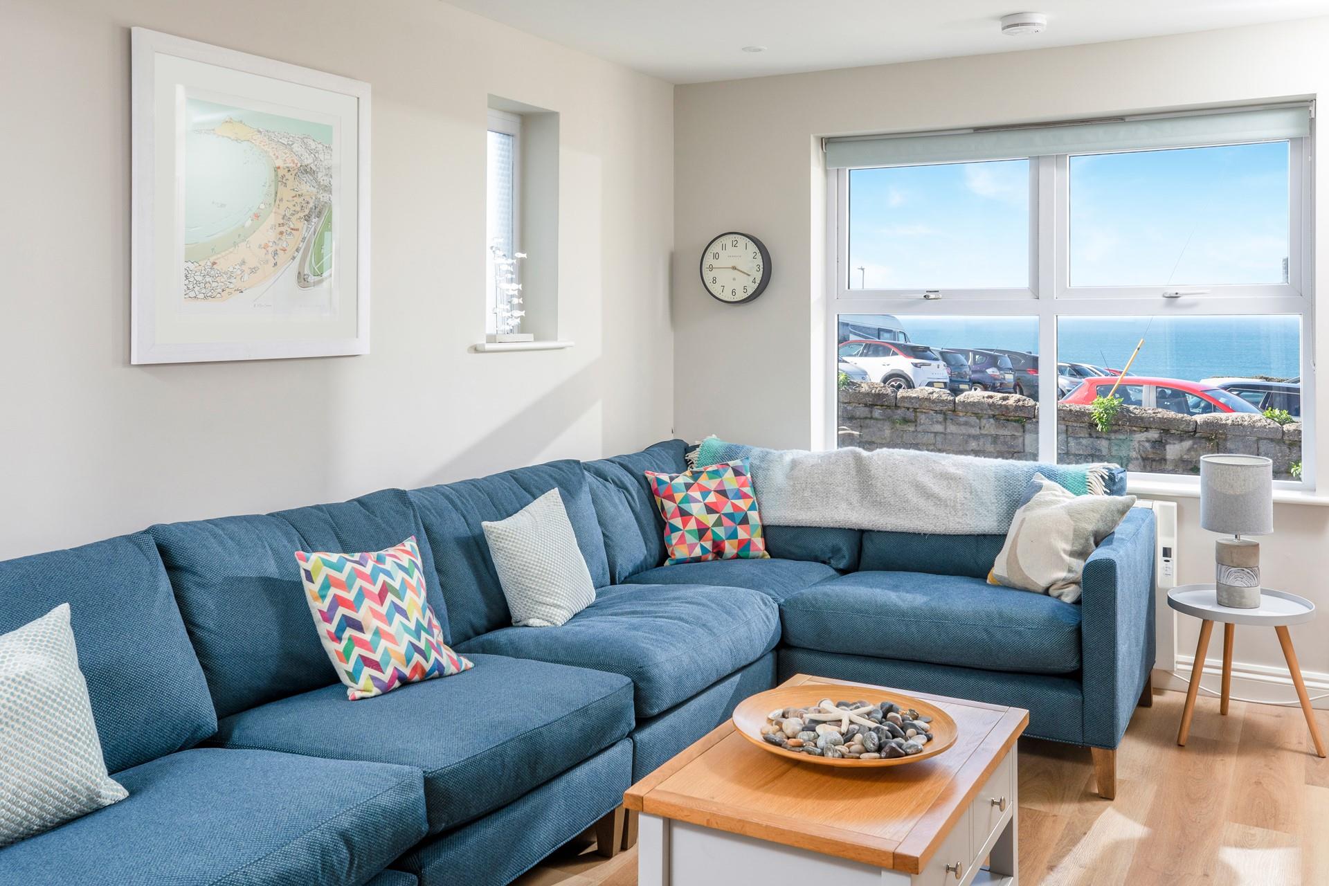 Sink into the plush sofas in the sitting room and unwind in the evening with a sea view.