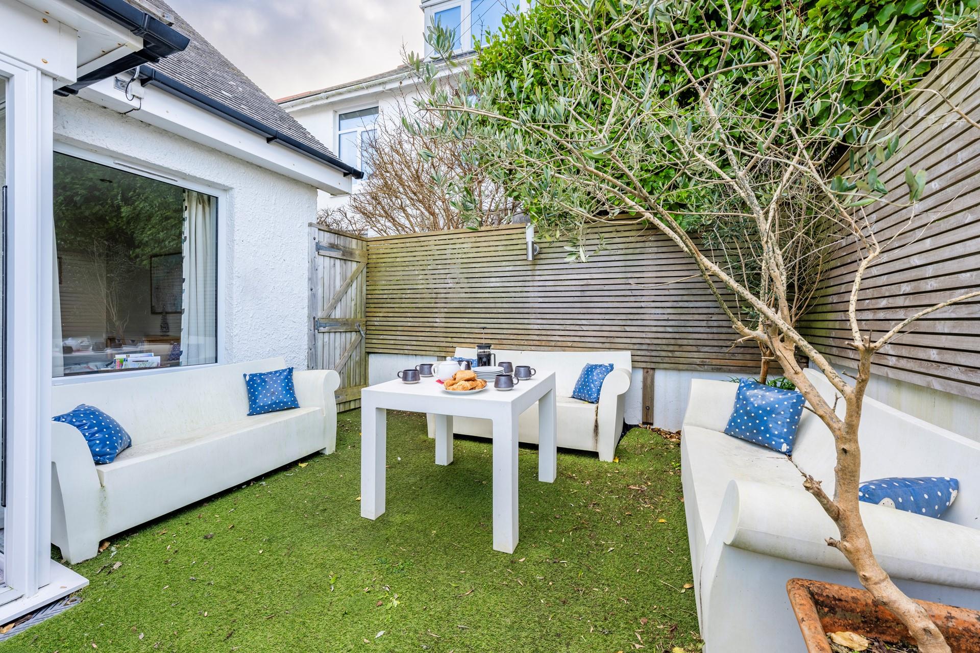 The sunny and private garden area, complete with a pizza oven, is ideal for relaxing on a warm summer's evening.