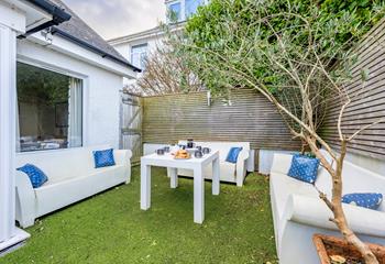 The sunny and private garden area, complete with a pizza oven, is ideal for relaxing on a warm summer's evening.