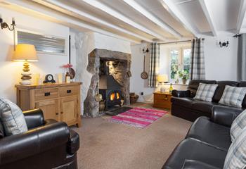 Traditional beams and an inglenook fireplace create a warm and welcoming sitting area. 