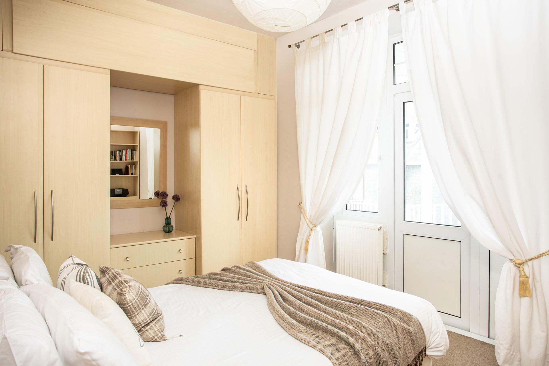 Bedroom 1 has doors that lead to the balcony terrace, so you can step out of bed and straight into the fresh Cornish air.