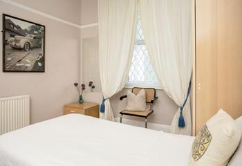 A cosy chair in the twin room offers a wonderful spot for parents to read bedtime stories.