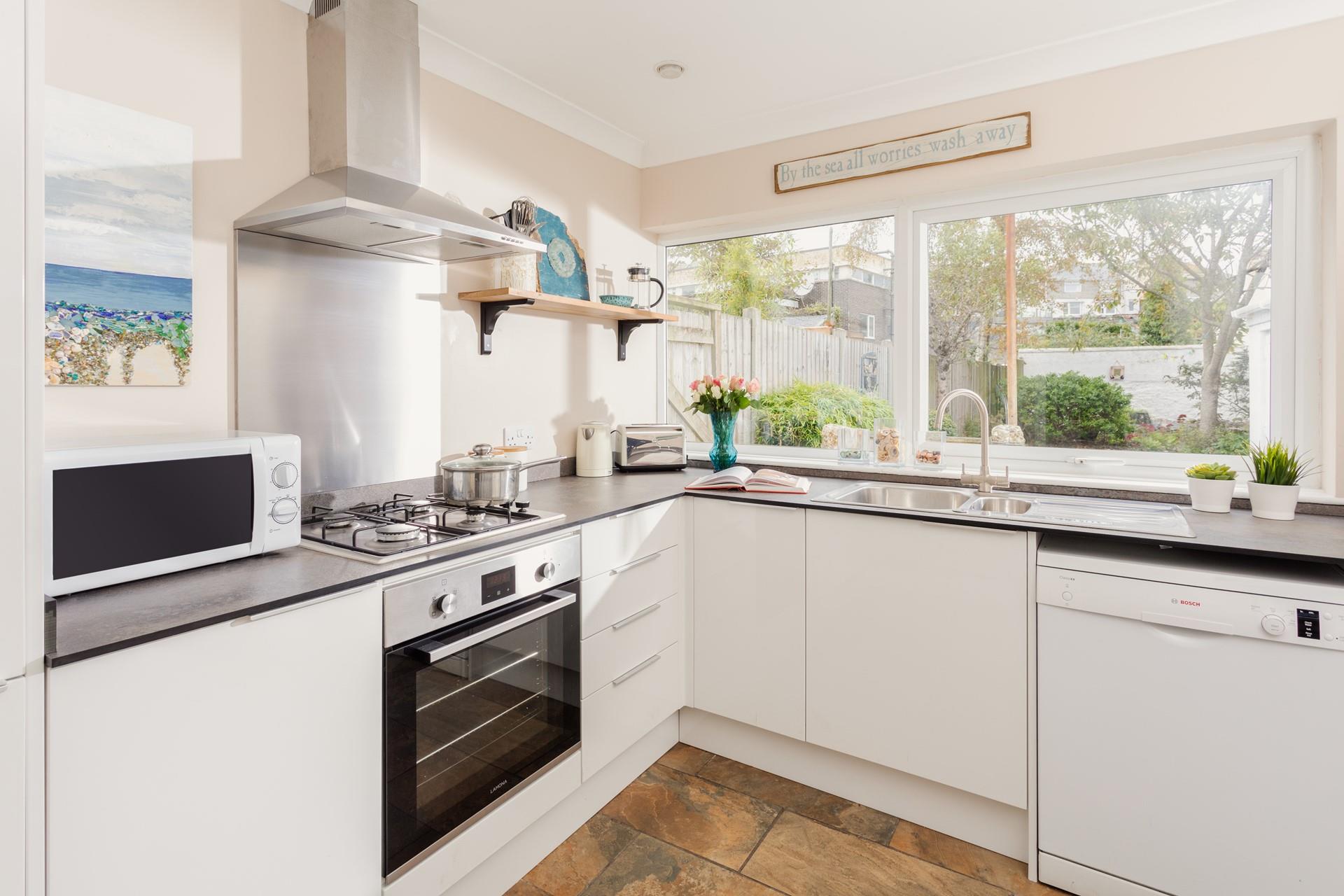 The modern and well-equipped kitchen provides the chef of the family a space to cook delicious meals.